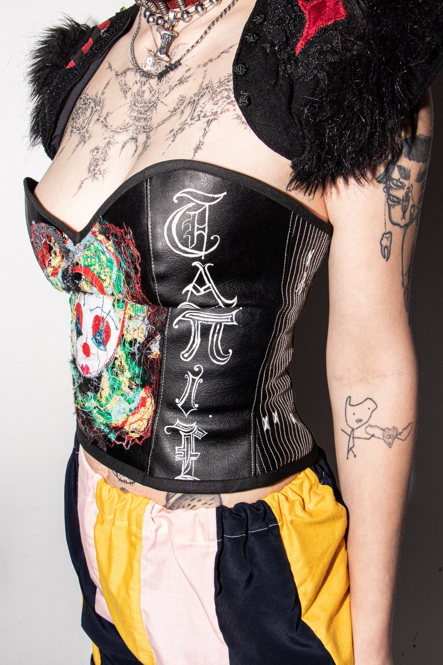 Pussy Tattie Clown thread portrait corset black pleather font striped
